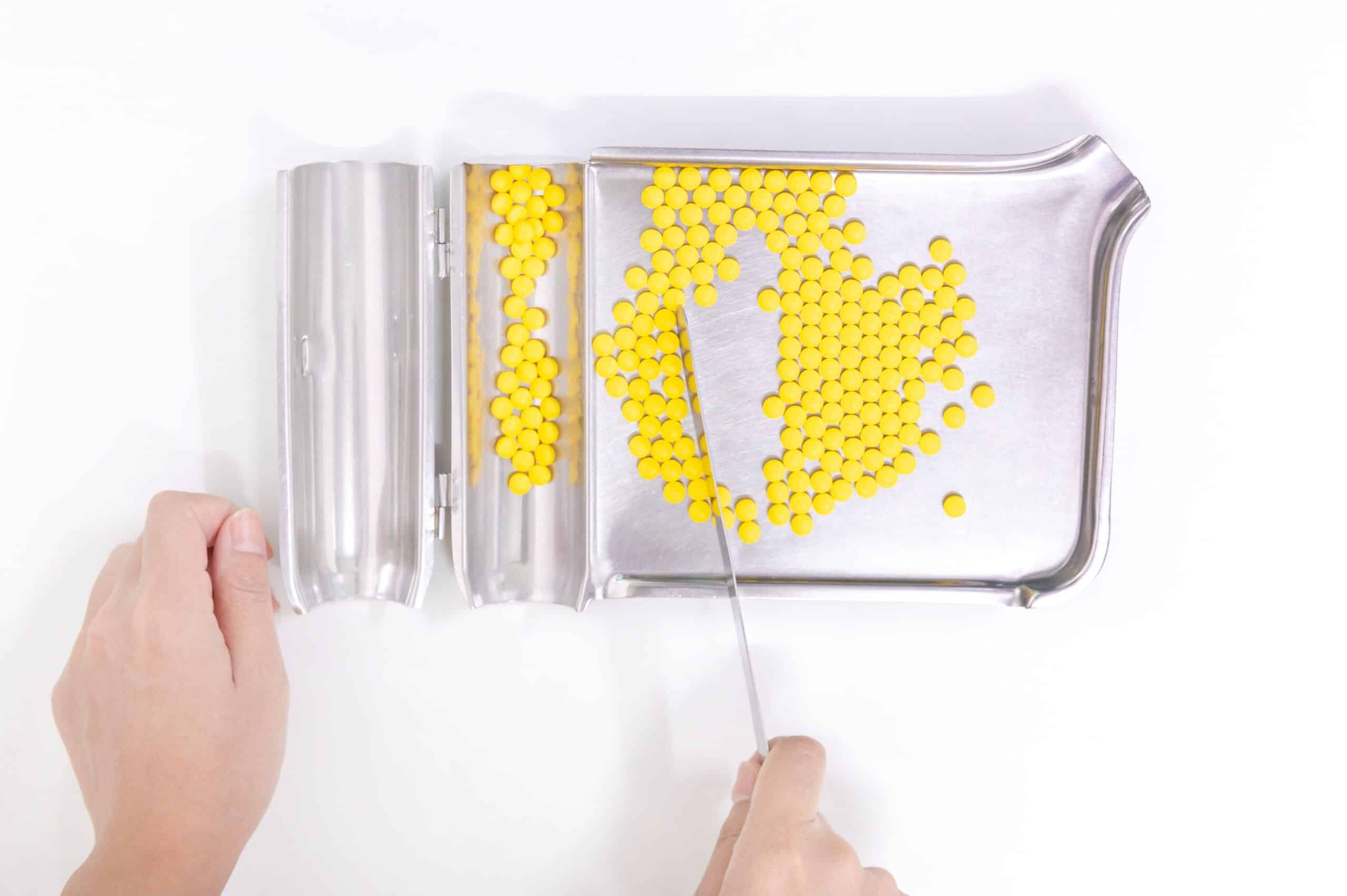 a-person-separating-yellow-pills