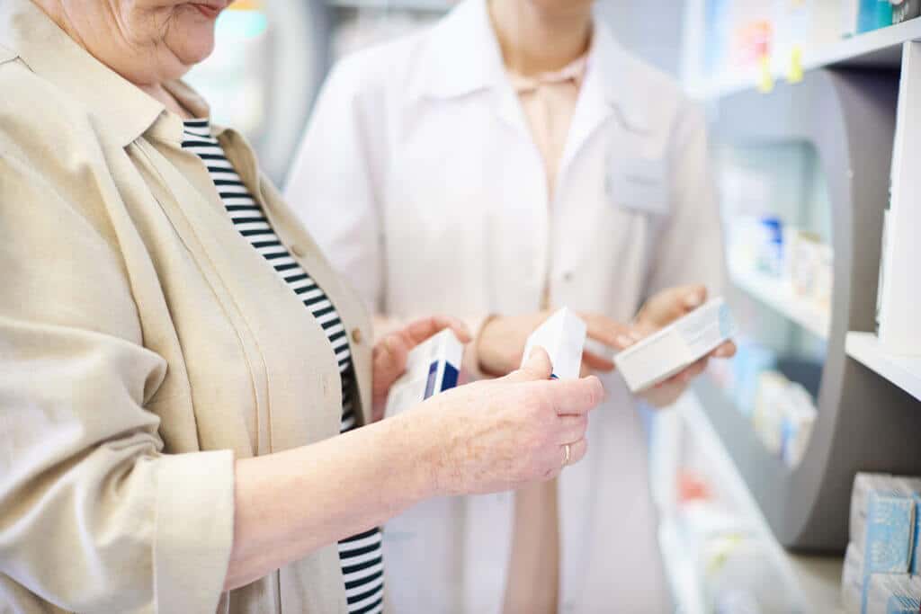 pharmacist-advising-senior-woman-on-medicine